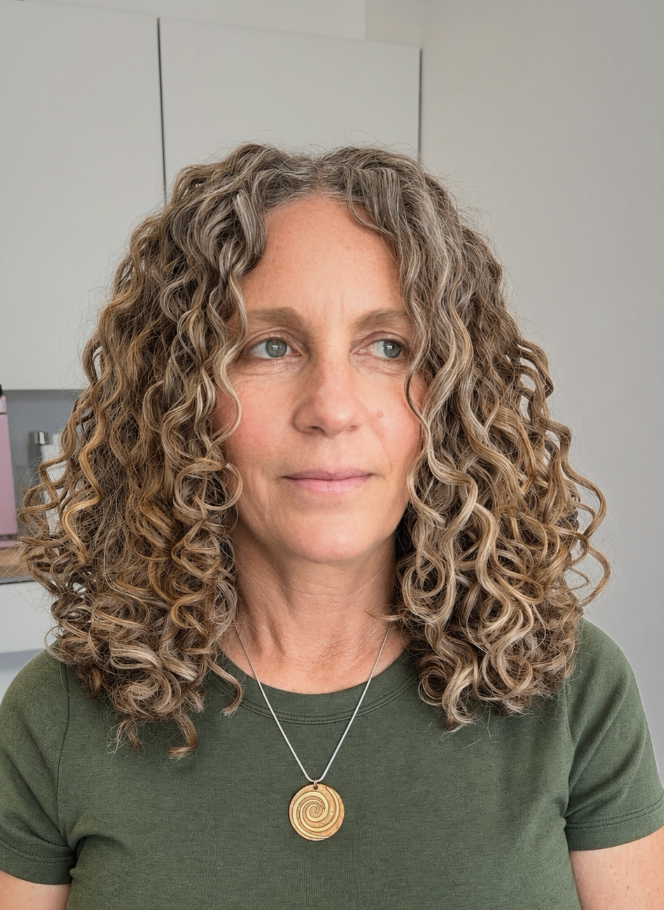 Client with shoulder-length dimensional blonde and silver curls
