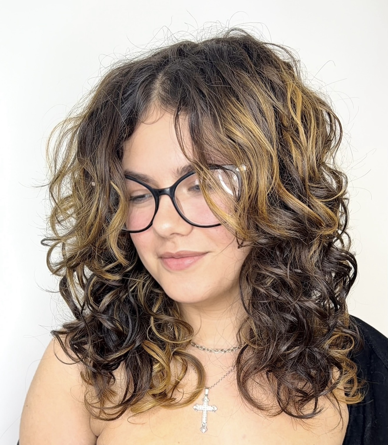 Client with layered dark curls and soft face-framing pieces