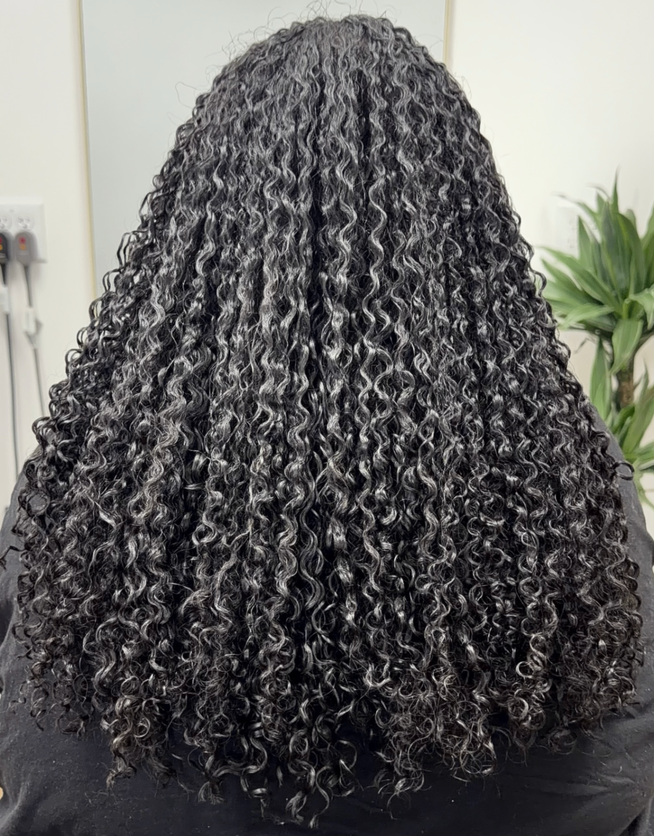 Long dark curly hair with even definition from root to ends
